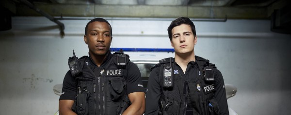 Programme Name: Cuffs - TX: n/a - Episode: n/a (No. n/a) - Picture Shows:  PC Ryan Draper (ASHLEY WALTERS), PC Jake Vickers (JACOB IFAN) - (C) Tiger Aspect - Photographer: Tiger Aspect